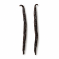 Two whole Madagascar vanilla beans on a white background