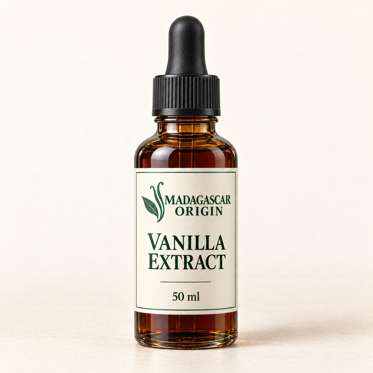 Madagascar Origin Vanilla Extract 50 ml in an amber glass dropper bottle with an ivory label and black pipette cap - packaging mockup